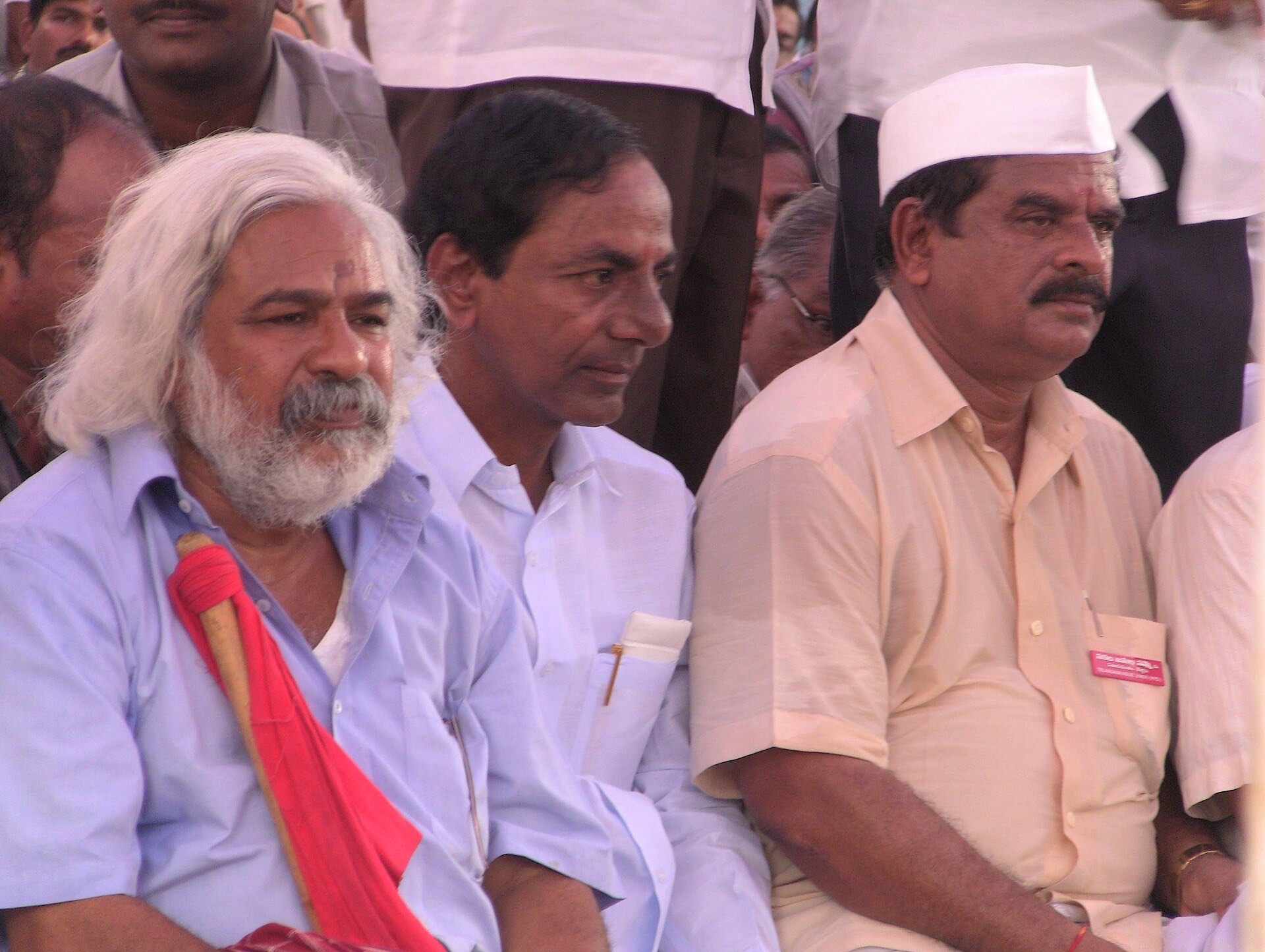 KCR seated beside the balladeer Gaddar and employees' leader Swamy Goud at a Telangana agitation gathering