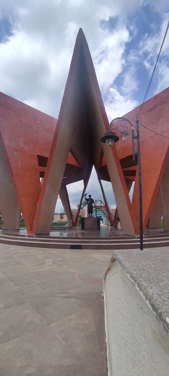 The Komaram Bheem memorial monument with his statue beneath soaring concrete flames