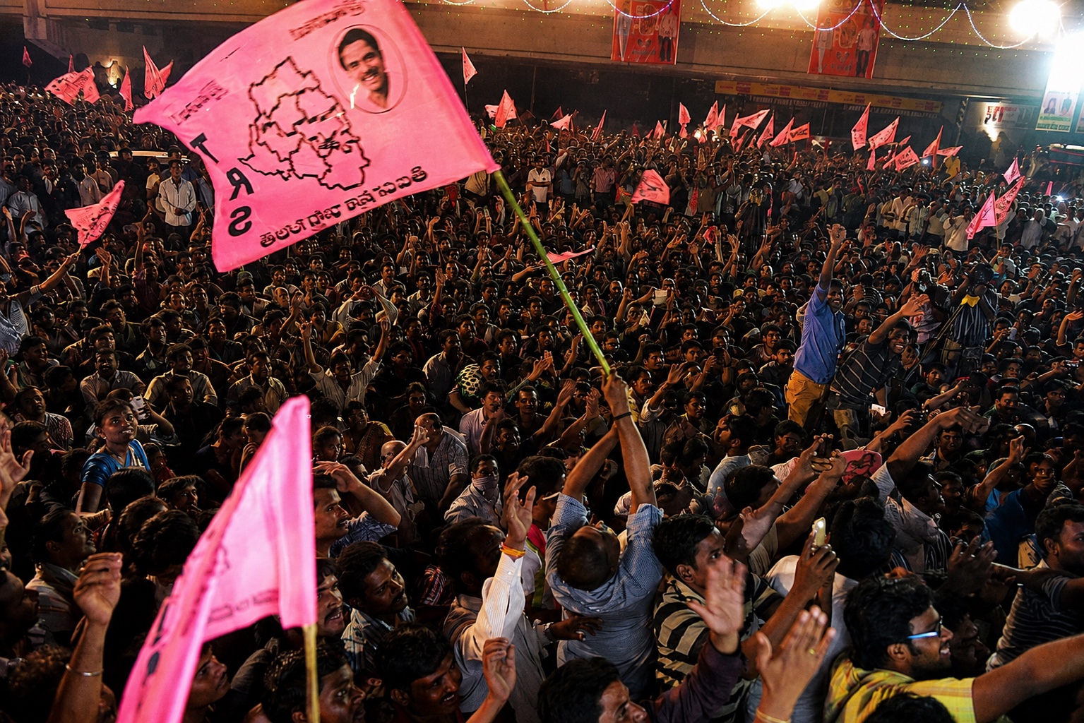 Crowds waving Telangana Rashtra Samithi flags in celebration of Telangana's formation, Hyderabad, 2014
